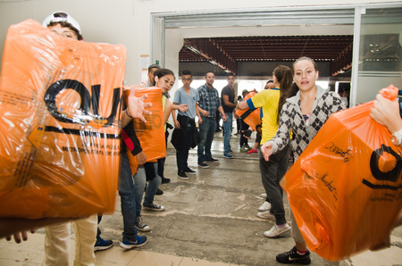 Quito, Ecuador - April 23, 2016: Volunteers of Quito providing disaster relief food, clothes, medicine and water for earthquake survivors in the coast. Gathered at Bicentenario Park.のeditorial素材