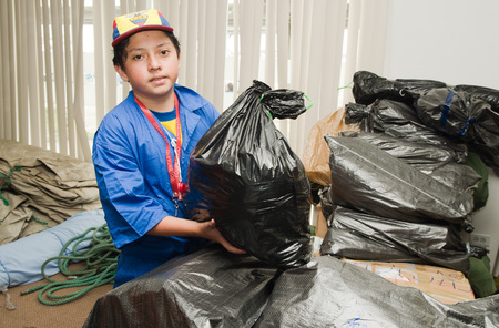 Quito, Ecuador - April 23, 2016: Unidentified Volunteers of Quito providing disaster relief for earthquake survivors in the coast. Gathered at Bicentenario Park.のeditorial素材