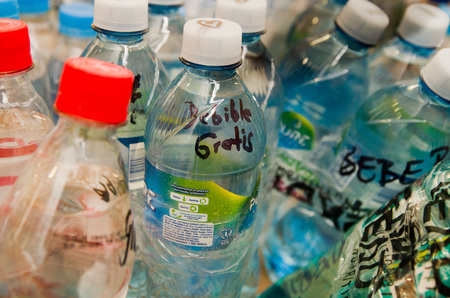 Quito, Ecuador - April 23, 2016: Water donated by citizens of Quito providing disaster relief for earthquake survivors in the coast. Gathered at Bicentenario Park.のeditorial素材