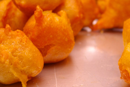 Delicious sweet fried doughs in a silver tray, ready to eat. Various of round form