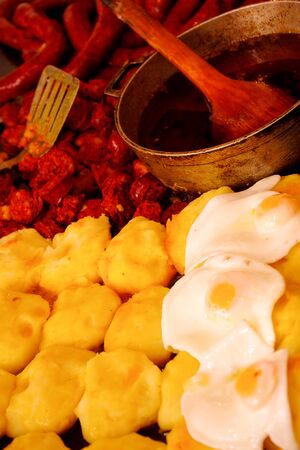 Delicious dish with various options, mashed potatoe, sausage and egg fried on oil ready to serveの写真素材