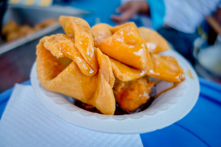 Bunuelos close up, traditional ecuadorian dessert served with honey and brown sugar, different forms of doughの写真素材