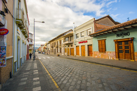 Cuenca, Ecuador - April 22, 2015: Bridgestone roads in city centre with charming and beautiful buildings architecture, small townhouses provides a very cozy atmosphere.のeditorial素材
