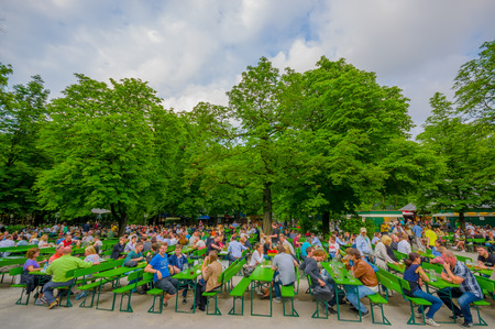 Munich, Germany - July 30, 2015: Famous local Chinesischer Turmgarden, full of people enjoying drinking beer on a beautiful summer day.のeditorial素材