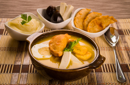 Elegant table setting with full serving of traditional fanesca soup and accessories.の写真素材