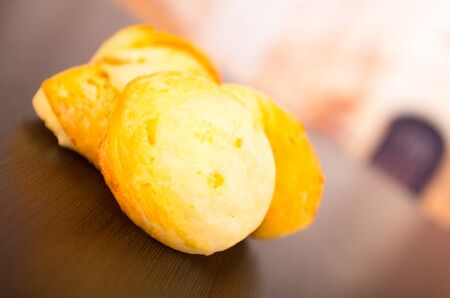 Delicious golden bread on a wooden table,の写真素材