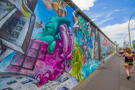 BERLIN, GERMANY - JUNE 06, 2015: Graffiti Berlin wall on the center of the city people walking around,のeditorial素材