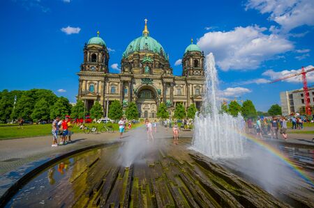BERLIN, GERMANY - JUNE 06, 2015: People enjoying the water on summer in front of Berlin Cathedral, nice view with rainbowのeditorial素材