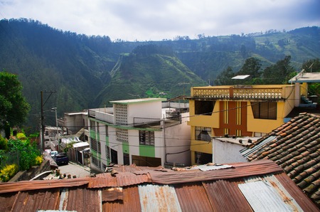 View from rooftops in Guapolo Quito overlooking green valley and other roofs.の写真素材