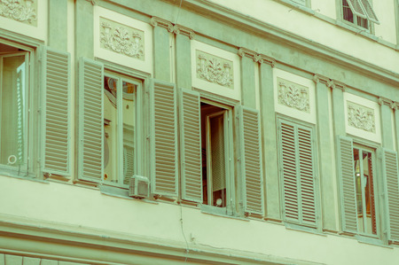 FLORENCE, ITALY - JUNE 12, 2015: Old green open windows in an old building, pinturesque and historic objects.のeditorial素材