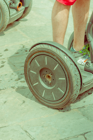 FLORENCE, ITALY - JUNE 12, 2015: Hoverboard wheel stand on paviment, new transportation way on Italy.のeditorial素材