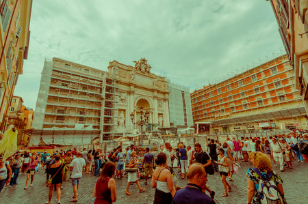ROME, ITALY - JUNE 13, 2015: La Fontana di Trevi is the biggest fountaine with fourty metters frontal size, reconstruction period with visitors around.のeditorial素材