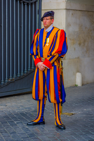 VATICAN, ITALY - JUNE 13, 2015: Man with typical uniform of swiss guard at Vatican country, colorful striped.のeditorial素材