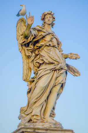ROME, ITALY - JUNE 13, 2015: Stone sculture in Rome, female angel with wings and a big nice dress, little bird in her shoulder.のeditorial素材