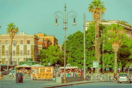 ROME, ITALY - JUNE 13, 2015: Nice park in the center of Rome, trees and palms around with people enjoying, public lightingのeditorial素材