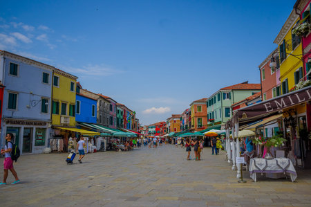 BURANO, ITALY - JUNE 14, 2015: Nice shop street in Burano city, turists enjoying a hot day during summer.のeditorial素材
