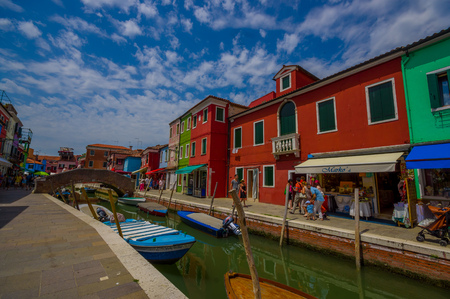 BURANO, ITALY - JUNE 14, 2015: Lovely nice bridge in the middle of water canals in Burano, color houses on the sides.のeditorial素材