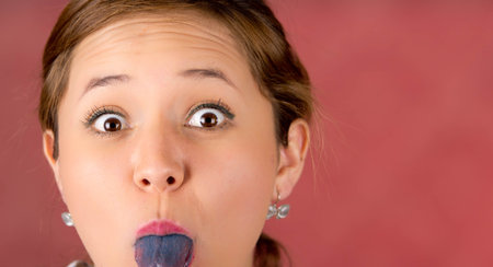 woman with open mouth spreading tongue colored in blue with pink background, surprised.