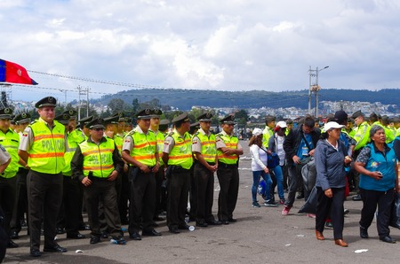 QUITO, ECUADOR - JULY 7, 2015: After the event, people getting out of the place and police guarding them untill the end.のeditorial素材