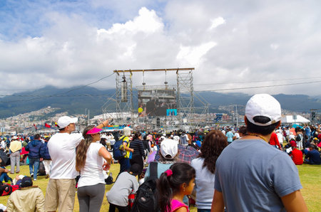 QUITO, ECUADOR - JULY 7, 2015: People very far from the scaffold looking and attending to mass on big screen.のeditorial素材