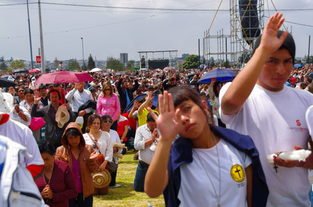 QUITO, ECUADOR - JULY 7, 2015: People raising the hand to receive blessings, pope Francisco mass...