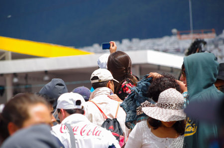 QUITO, ECUADOR - JULY 7, 2015: Unidentified woman trying to take a good photo to pope Francisco, big event mass.のeditorial素材