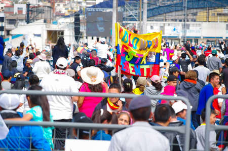 QUITO, ECUADOR - JULY 7, 2015: In the middle of thousand people, colored flag with the words, Colombia is present here.のeditorial素材
