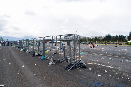 QUITO, ECUADOR - JULY 7, 2015: After pope Francisco mass, garbage in the place and metal mesh of the police.のeditorial素材