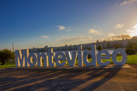 MONTEVIDEO, URUGUAY - MAY 04, 2016: montevideo's sign damaged by some graffitis with the city as background.のeditorial素材
