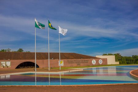 IGUAZU, BRAZIL - MAY 14, 2016: the brazilian flag next to the state and city flags at the entrance of the iguazu national park.のeditorial素材