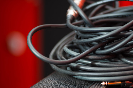 Closeup standard black audio cables rolled into bundle, studio equipment concept.の写真素材