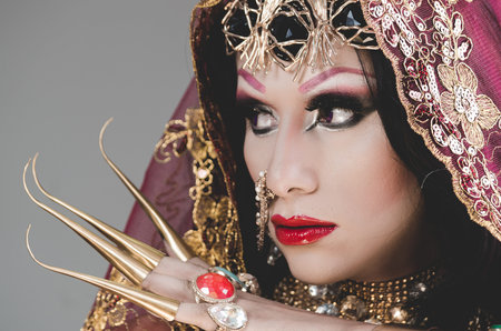 Headshot woman dressed in traditional hindu clothing, heavily decorated in gold and elegant veil,...