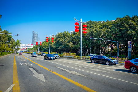SHENZEN, CHINA - 29 JANUARY, 2017: Inner city streets and sorroundings, beautiful mix of green areas combined with buildings, modern architecture, light traffic, totally blue skiesのeditorial素材