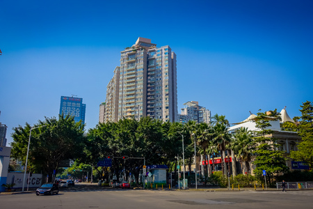 SHENZEN, CHINA - 29 JANUARY, 2017: Inner city streets and sorroundings, beautiful mix of green trees combined with buildings, modern architecture, light traffic, totally blue skiesのeditorial素材