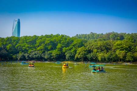 SHENZEN, CHINA - 29 JANUARY, 2017: Inside Lian Hua Shan park, large recreational area, water lake sorrounded by trees with boats for hire, tourists enjoying a beautiful blue sky,のeditorial素材