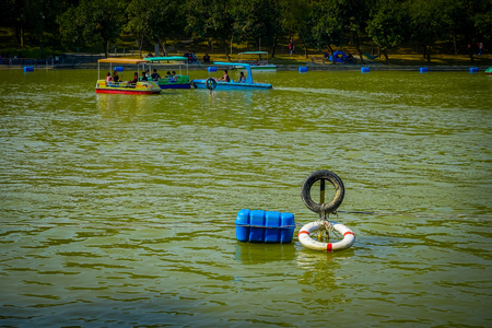 SHENZEN, CHINA - 29 JANUARY, 2017: Inside Lian Hua Shan park, large recreational area, water lake sorrounded by trees with boats for hire, tourists enjoying a beautiful blue sky,のeditorial素材