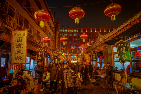 BEIJING, CHINA - 29 JANUARY, 2017: People walking around charming streets with small restaurants, traditional architecture and decorations, local Donghuamen food market conceptのeditorial素材