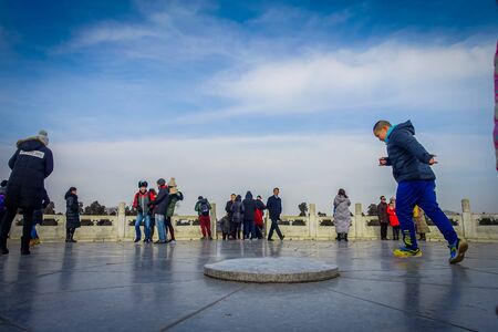 BEIJING, CHINA - 29 JANUARY, 2017: Tourist standing on flat stone inside temple of heaven compund, an imperial complex with various religious buildings located in southeastern central city area, nice blue skyのeditorial素材