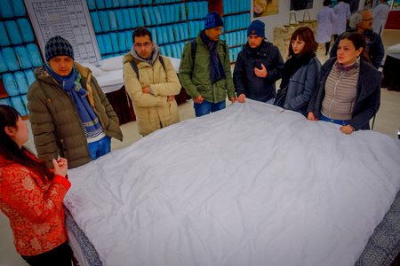 BEIJING, CHINA - 29 JANUARY, 2017: Visiting traditional chinese silk factory, workers performing their tasks creating the smooth textile.のeditorial素材