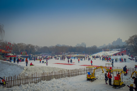 BEIJING, CHINA - 29 JANUARY, 2017: People attending the new years fair in Longtan Park, playing on frozen water channel,のeditorial素材