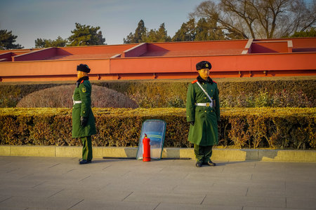 BEIJING, CHINA - 29 JANUARY, 2017: Chinese army guards standing inside forbidden city wearing green...