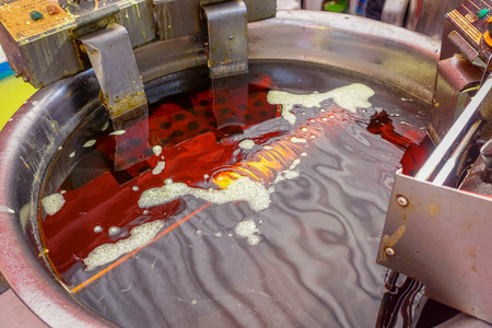 CHONGYUANG TEMPLE, CHINA: Delicious curly potato fries being prepared by chinese man at food market around temple areaの写真素材