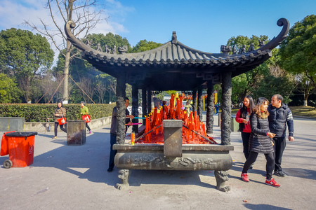 CHONGYUANG TEMPLE, CHINA - 29 JANUARY, 2017: Wooden table structure with many red candle lights, part of temple complex, ensemble of temples, lakes and gardens, beautiful buildings and architectureのeditorial素材