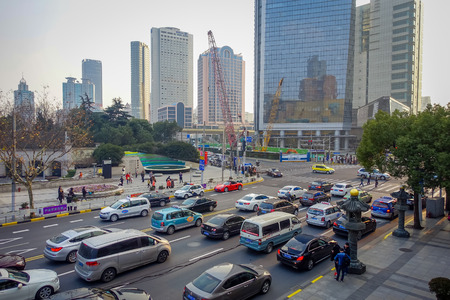 SHANGHAI, CHINA - 29 JANUARY, 2017: Trafficated city streets around Jingan temple neighborhood, modern office buildings in backgroundのeditorial素材