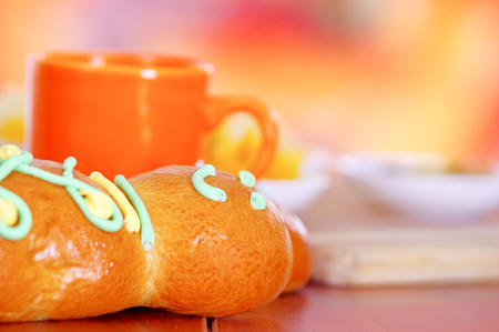 Elegant setup traditional tasty latin american guagua breads, colorful sugar decorations, orange cup with colada morada berry juice next to it, day of the dead conceptの写真素材
