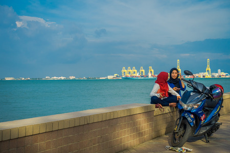 malay women sitting by the seaのeditorial素材