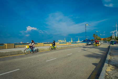 George Town, Malaysia - March 10, 2017:  scenic view of unknown muslim women riding bicycles    , a waterfront location in the heart of the city.のeditorial素材