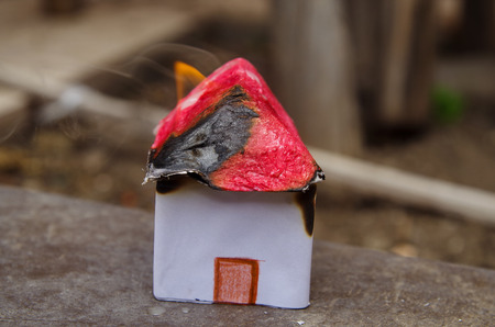Small and beautiful house made of paper burning, house model conceptの写真素材