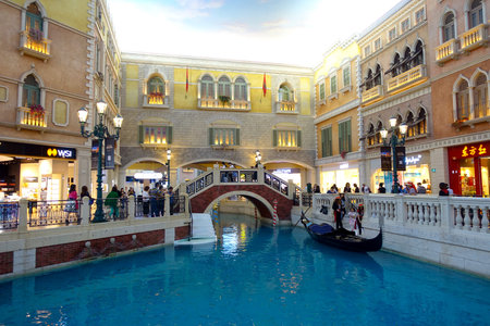 MACAU, CHINA- MAY 11, 2017: An unidentified people having a trip in a venetian gondola inside of a beautiful luxury hotel the Venetian Resort Hotel and Casinoのeditorial素材