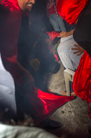 Quito, Ecuador - May 27, 2015: An unidentified man dressed up with red cap and smiling in the diabladaのeditorial素材